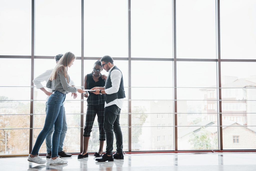 Brick Marketing strategists reviewing AI search results together in the Boston office